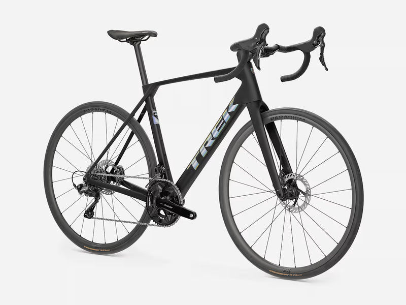 A black Trek road bicycle with drop handlebars, disc brakes, and a sleek carbon fiber frame, shown from a three-quarter angle against a light gray background.