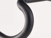 Close-up of a blackhandlebar with measurement markings on the handlebar curve, against a white background