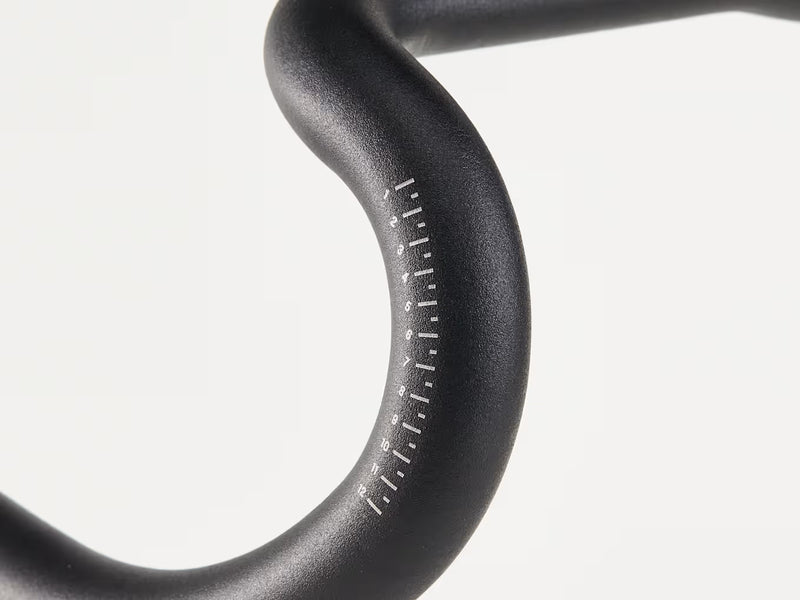 Close-up of a blackhandlebar with measurement markings on the handlebar curve, against a white background