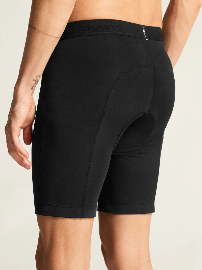 Close-up of black Craft Everyday Bike Liner Shorts on a model, back three-quarter view showing the leg cuff and seat stitching