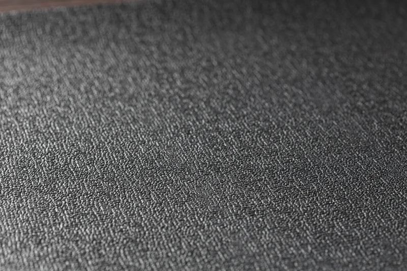 Close‑up of the JetBlack Trainer Mat’s textured black rubber surface.