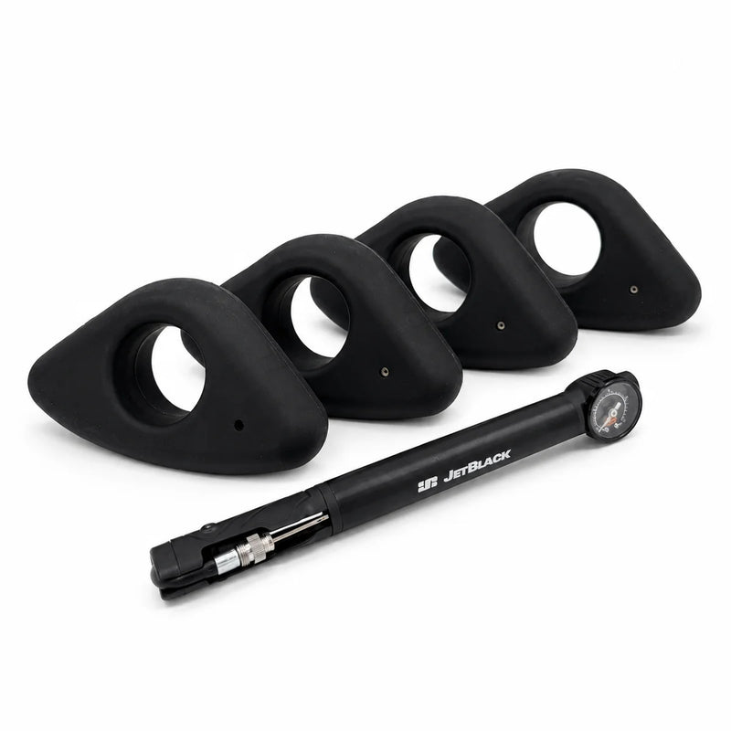 Product shot of four round JetBlack Freedom Rocker Feet with the pump on a white background, no packaging visible.