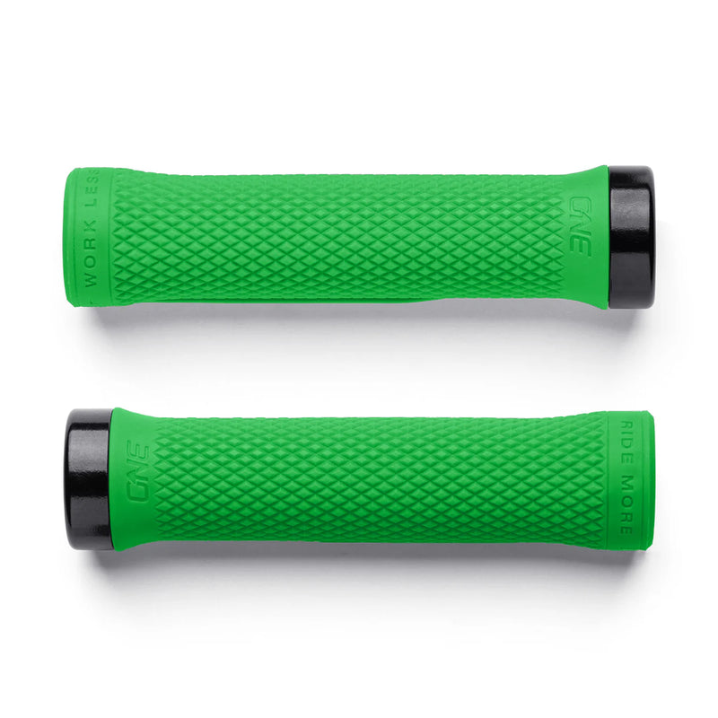 Two green bicycle grips with black ends on a white background