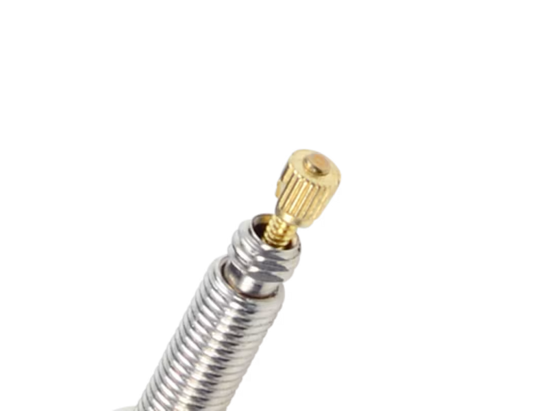 Metal hose with gold fitting on a white background