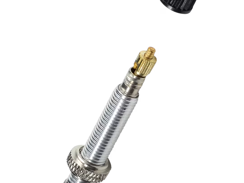 Metallic nozzle with gold fitting on a white background