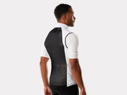 Person wearing a black and white cycling jersey on a plain background