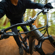 Close-up of a mountain bike with a blurred forest background
