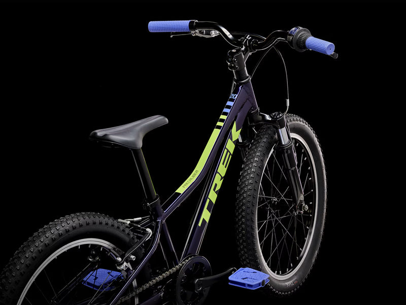 Children's bicycle with blue handlebars and seat on a black background