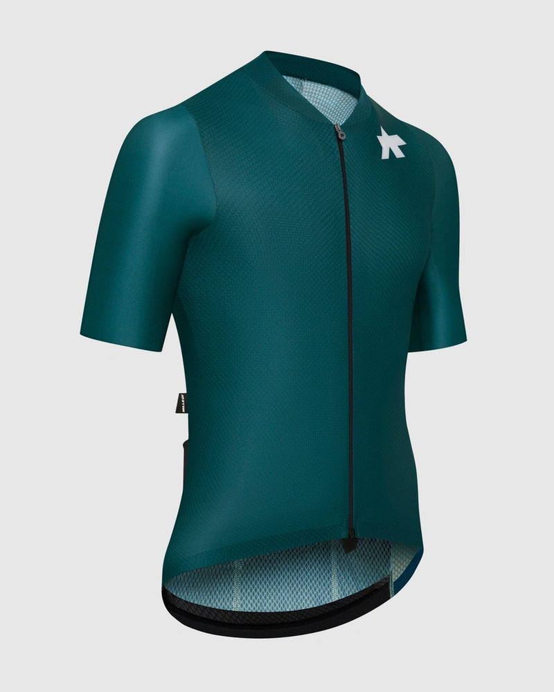 Green cycling jersey with a brand logo on a light gray background