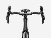 Trek Domane SL 4 Gen 5 in Matte Deep Smoke, close-up of handlebars, Shimano Tiagra brake controls, and Trek frame logo