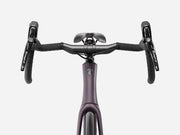 Trek Domane SL 4 Gen 5 in Matte Nightshade, close-up of handlebars, Shimano Tiagra brake controls, and Trek frame logo