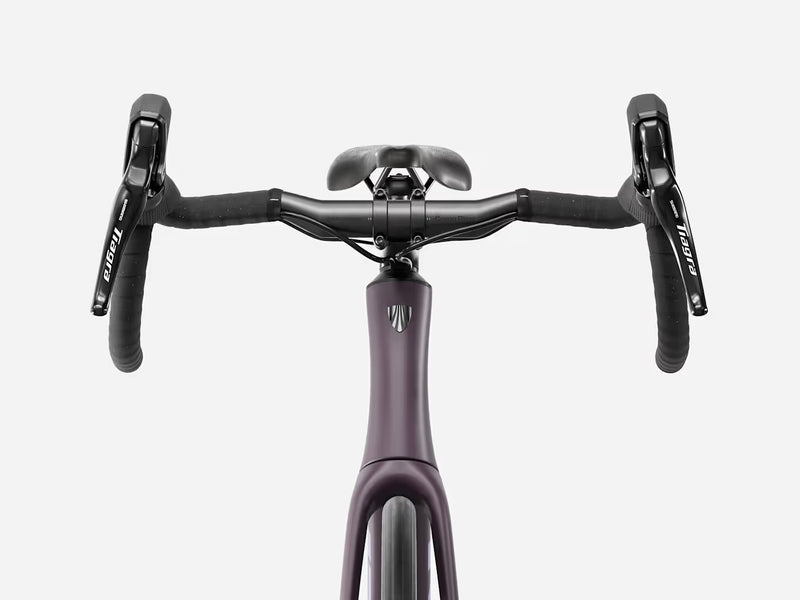 Trek Domane SL 4 Gen 5 in Matte Nightshade, close-up of handlebars, Shimano Tiagra brake controls, and Trek frame logo