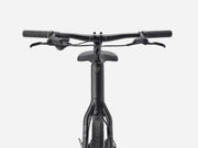 Front view of a black stepover cruiser electric bicycle showing the handlebars, saddle, and frame against a light gray background.