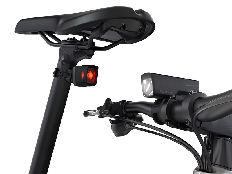 Close-up of a motorcycle handlebar with lights and controls on a white background