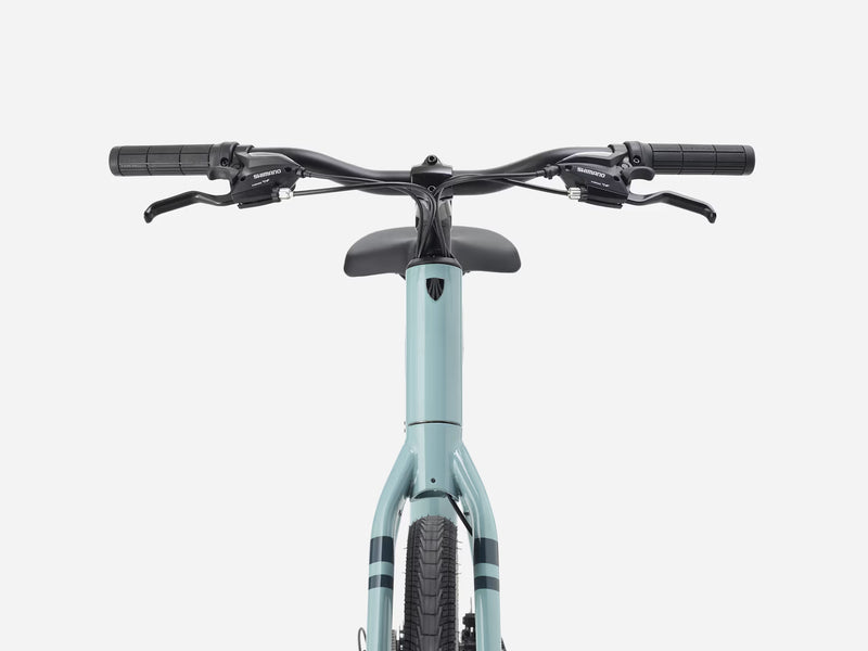 Light blue bicycle with black handlebars on a white background