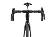 Close-up of a black bicycle handlebar and frame on a white background