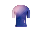 Rapha cycling jersey shown from the back, featuring a pink-to-blue gradient design with the brand name 'RAPHA' printed vertically in white on the lower back. Back pockets visible.