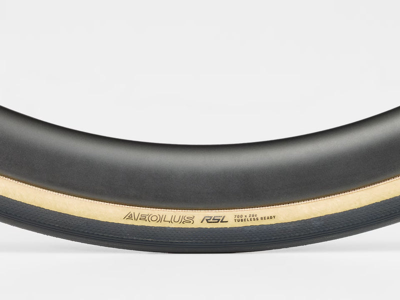 Close-up of a bicycle tire with 'Aeolus RSL' branding on a white background