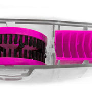 Close-up of a bright pink brush with black bristles inside a clear plastic case, alongside a matching pink compartment.