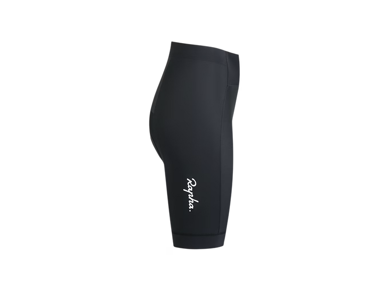 Black Rapha cycling shorts shown from the side profile on a solid white background, featuring the white script  Rapha logo near the lower leg.