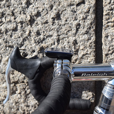 side view of cateye computer mounted on a road bike handlebar