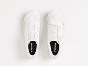White sneakers with 'Trek' branding on a light gray background
