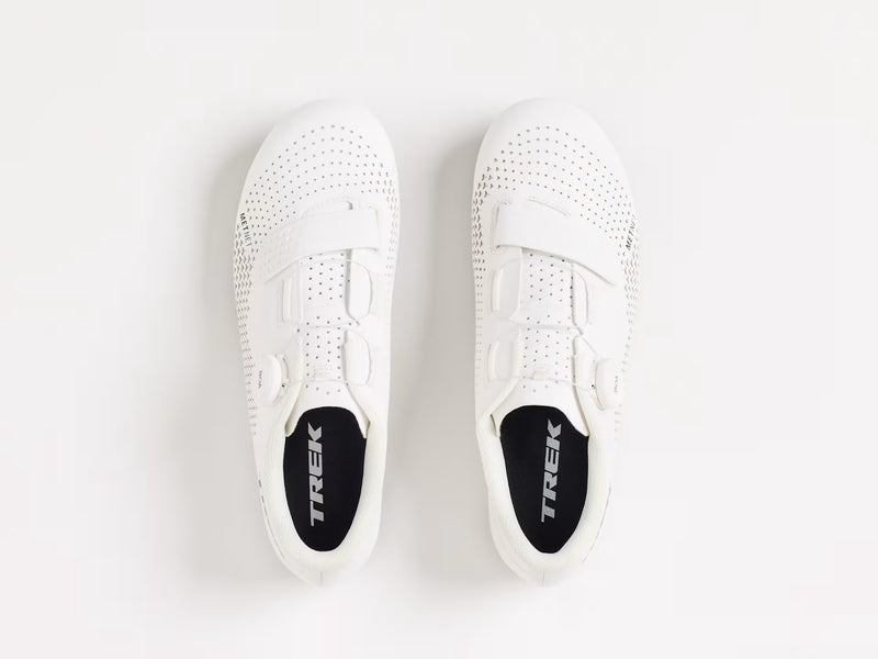 White sneakers with 'Trek' branding on a light gray background