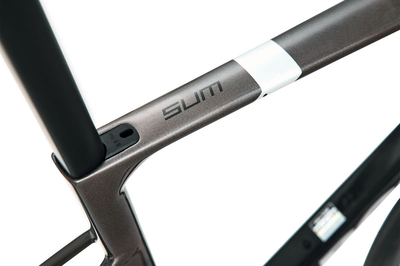 Close-up of a bicycle frame with 'SUM' branding on a white background