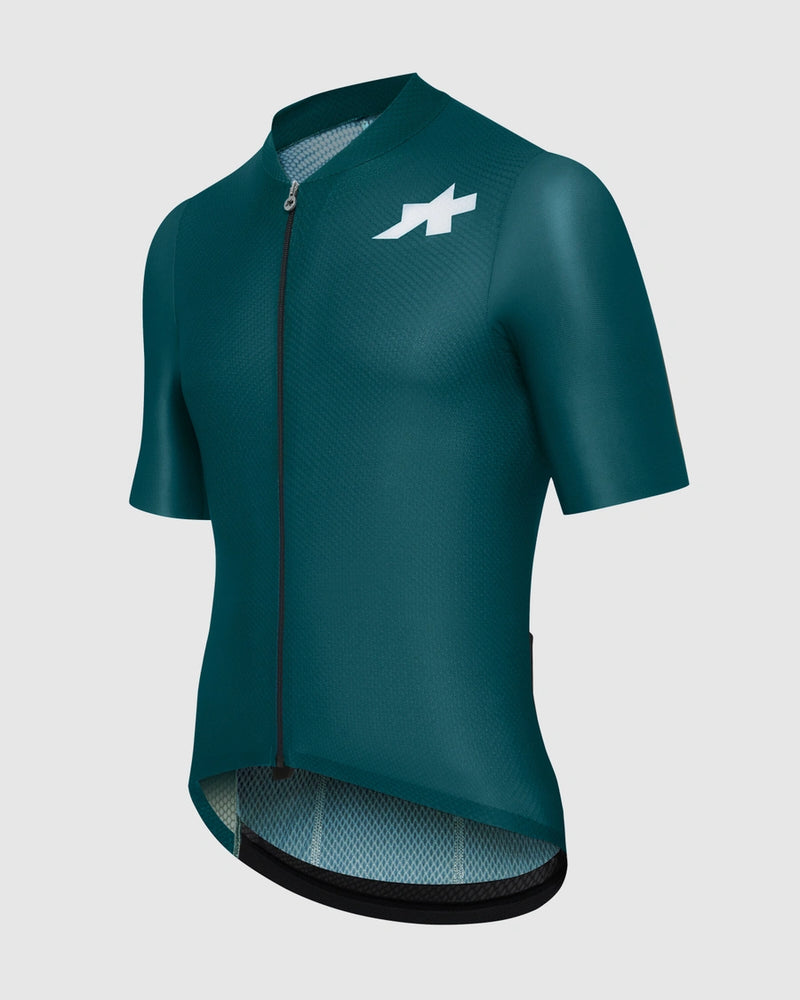 Green cycling jersey with a logo on a light gray background