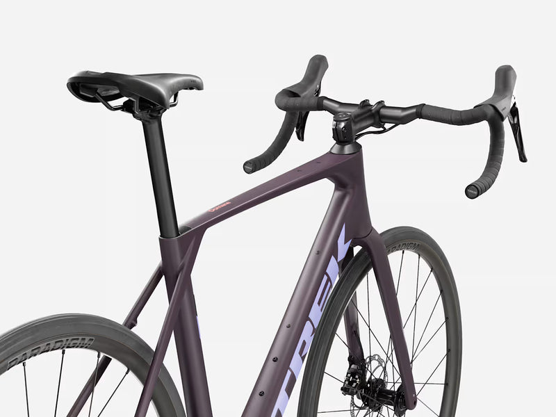 Trek Domane SL 4 Gen 5 in Matte Nightshade, rear three-quarter view showing Domane frame logo, Bontrager Paradigm wheels, handlebars, and Trek bar-end detail