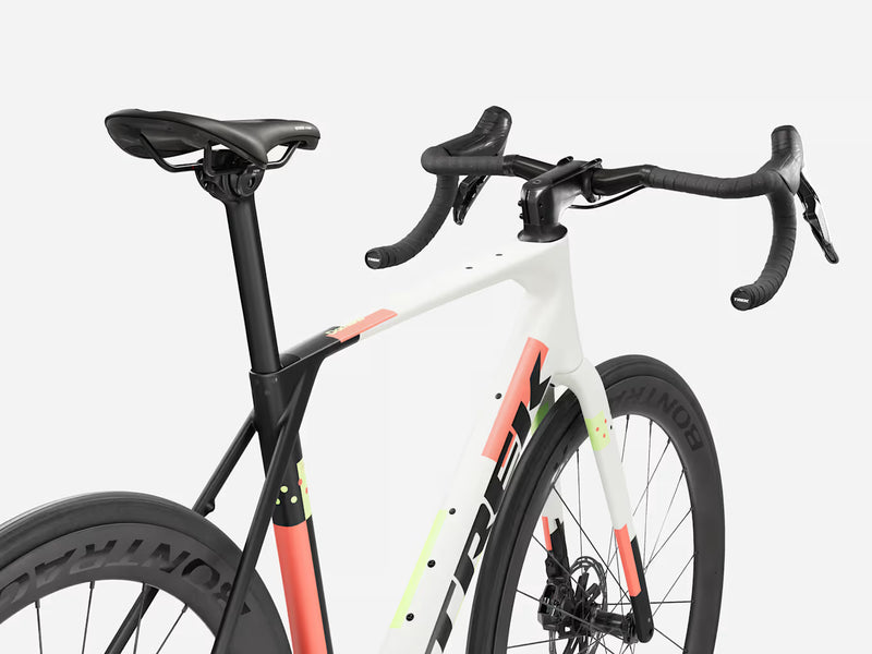 White endurance road bicycle with black and orange accents on a white background