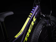 Close-up of a bicycle frame with 'Trek' branding on a black background