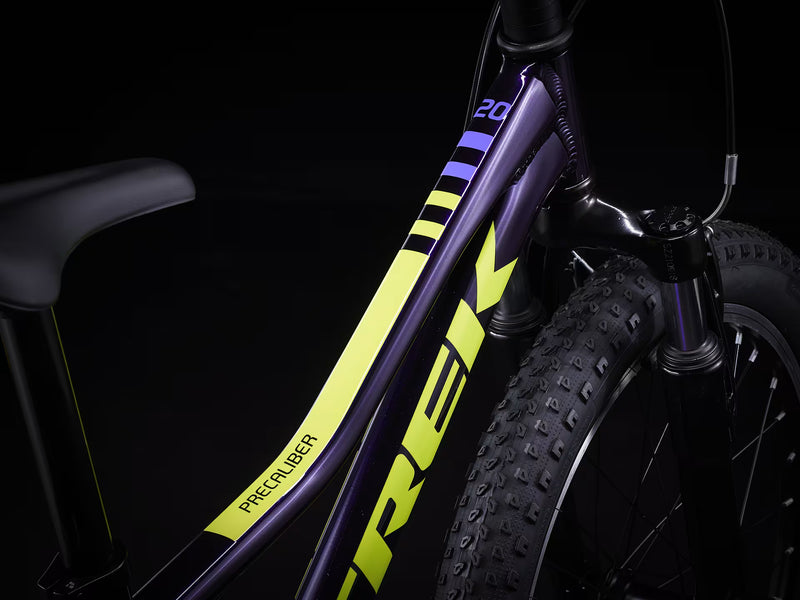 Close-up of a bicycle frame with 'Trek' branding on a black background