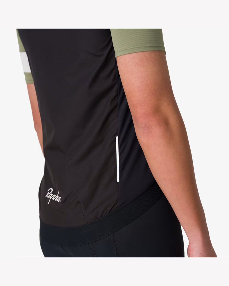 Rapha Core Cycling Gilet worn by a model, diagonal back view showing the fit and length over cycling shorts