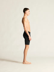 Full-length side view of man wearing black Craft Everyday Bike Liner Shorts showing the side stitching