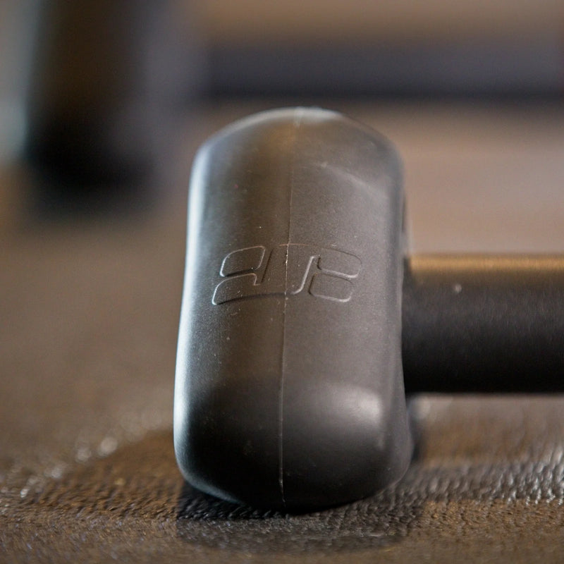 Closeup lifestyle shot showing JetBlack Freedom Rocker Feet attached to the trainer’s feet, positioned on a training mat.
