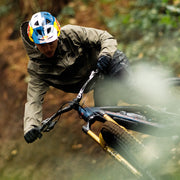 Person riding a mountain bike through a forest