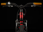 Close-up of a bicycle handlebar with yellow grips on a black background