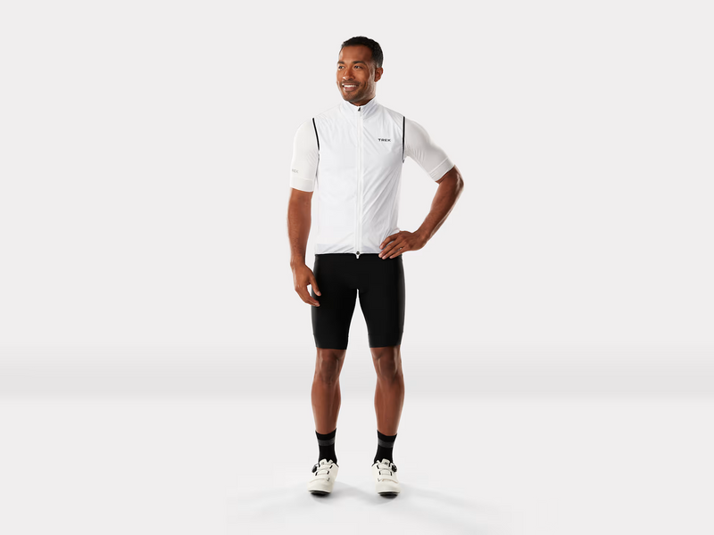 Man wearing a white cycling jersey and black shorts on a white background