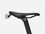 Black bicycle seat with perforated design on a white background