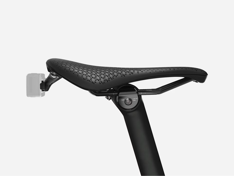 Black bicycle seat with perforated design on a white background
