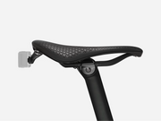 Black bicycle seat with perforated design on a white background