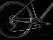 Close-up of a bicycle wheel and chain on a black background