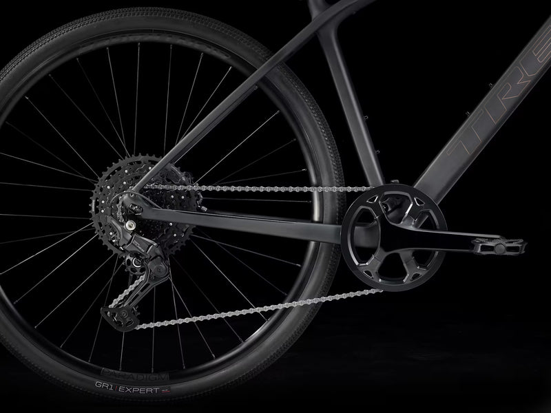 Close-up of a bicycle wheel and chain on a black background