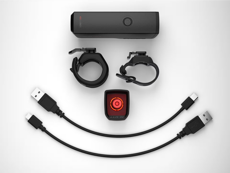 Collection of electronic components including a power bank, USB cables, and a red light device on a white background.
