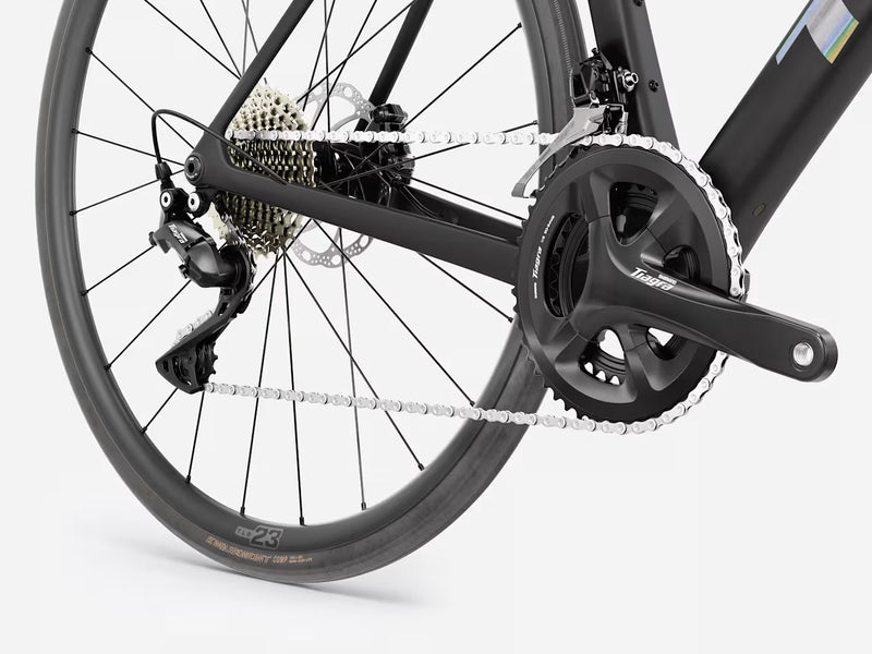 Trek Domane SL 4 Gen 5 in Matte Deep Smoke, close-up of Shimano Tiagra crankset, front derailleur, chain, rear derailleur, and Bontrager tire details