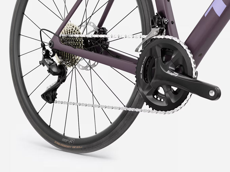 Trek Domane SL 4 Gen 5 in Matte Nightshade, close-up of Shimano Tiagra crankset, front derailleur, chain, rear derailleur, and Bontrager tire details
