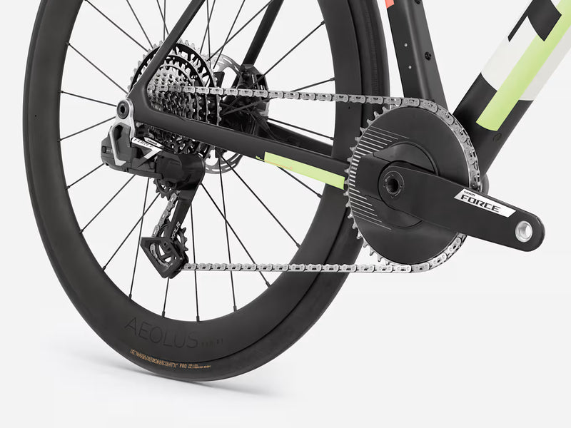 Close-up of a endurance road bicycle wheel with chain and gear on a white background