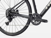Close-up of a hybrid fitness bicycle chain and gear system on a white background
