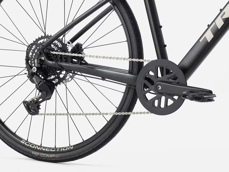 Close-up of a hybrid fitness bicycle chain and gear system on a white background